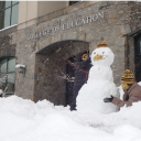 Kids build snowmen in front of RCOE