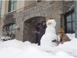 Kids build snowmen in front of RCOE